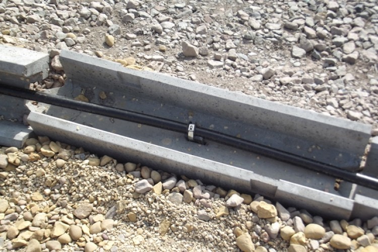 Ander-fin ties cables to the bed of the precast trough 