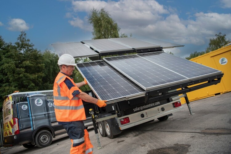Unfolding a solar panel. Courtesy of Tim Wallace Photography.