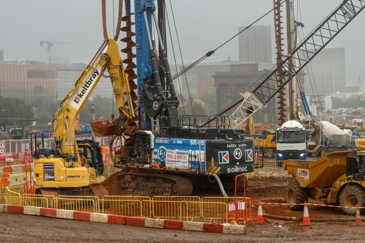 Three 95-tonne piling rigs are boring 2,000 concrete piles