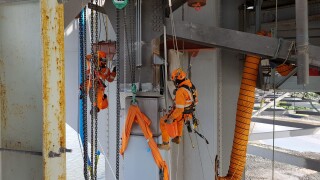 Members of the Spencer Group project team at work below the Forth Road Bridge deck