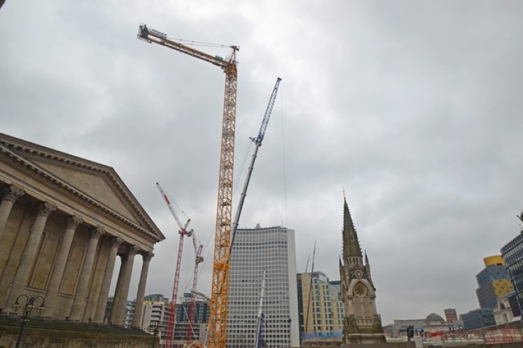 The first Potain tower crane being erected