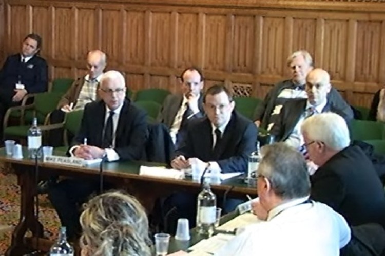 Mike Peasland, left, gives evidence to the committee