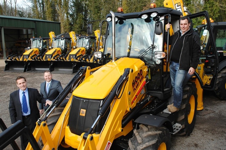 Fraser Hood (right) with his new JCBs. Darren Bland of JCB and Mark Robinson of JCB Gunn look on
