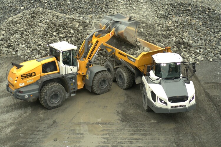 Liebherr L580 loader fills a TA230 articulated dump truck
