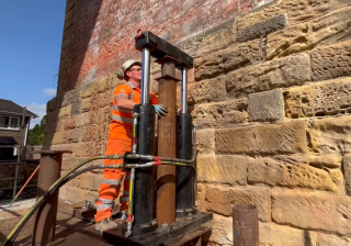 Hydraulic rams push steel piles into soft clays overlying sandstone