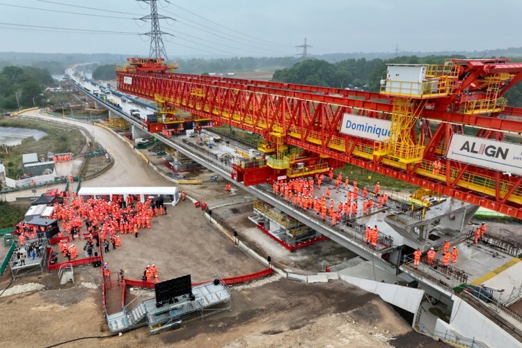 The final pre-cast deck segment is lowered into place with great ceremony and fanfare