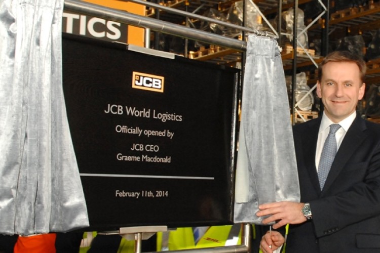 JCB&rsquo;s new CEO Graeme Macdonald unveils a plaque to mark the official opening of JCB World Logistics