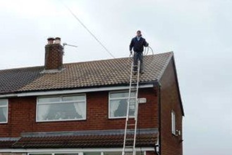 Arthur Boswell's worker on the roof of the house in Hyde